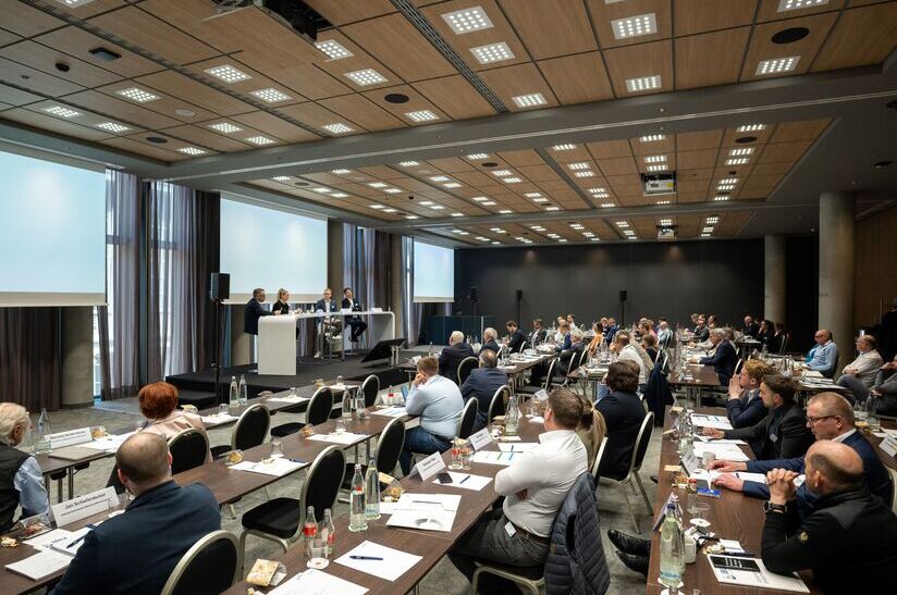 Konferenz über Stahl und Fachliteratur in einem modernen Seminarraum.